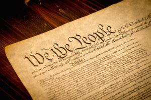 The Constitution of the United States of America on a wooden desk