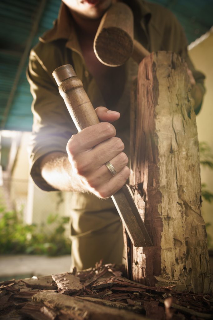 Young Sculptor Artist Working And Sculpting Wood Statue-3